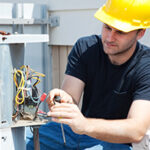 Technician performing HVAC maintenance in Ocean County