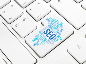 White keyboard with word cloud of SEO Ocean County words in blue on one of the keys